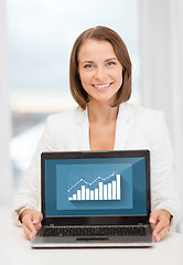 Image showing smiling businesswoman with laptop computer