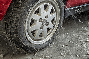 Image showing 80’s tire among cobwebs