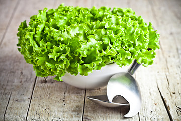 Image showing lettuce salad in a bowl and spoons 