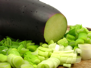 Image showing Eggplant and cutted  spring onion on wooden plate 