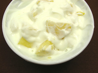 Image showing Pieces of pineapple in yogurt and and a white bowl of chinaware