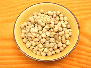 Image showing One bowl of ceramic with garbanzos on orange