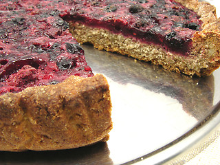 Image showing Cutted berry cake on a cake tray