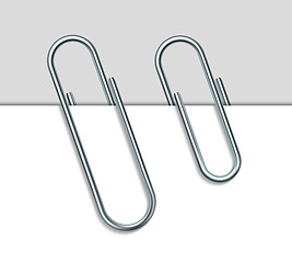 Image showing Metal paperclip and paper