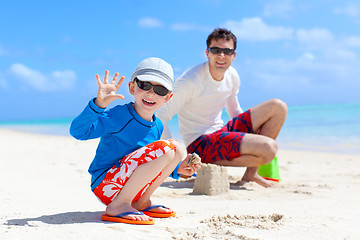 Image showing family building sand castle