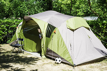 Image showing Child peeks from a tent