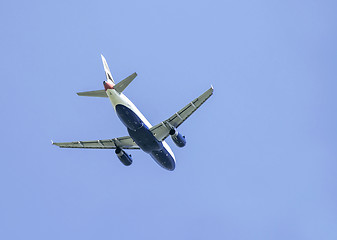 Image showing Flying plane on blue sky background