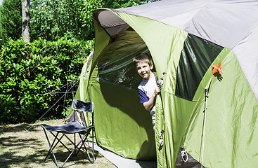 Image showing Child peeks from a tent