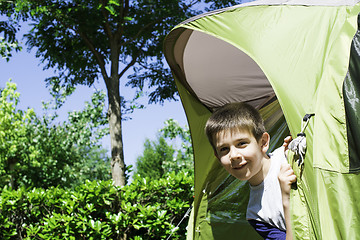 Image showing Child peeks from a tent