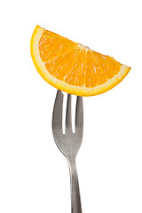 Image showing Orange held by a fork