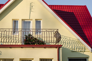 Image showing country house and fallen Christmas tree on balcony 