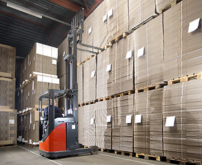 Image showing forklift lifting from top shelf