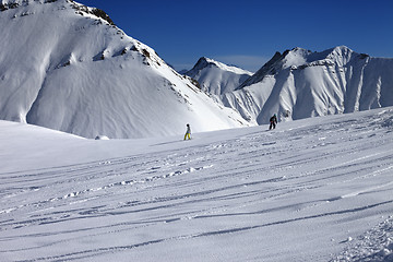 Image showing Snowboarders downhill on off piste slope with newly-fallen snow
