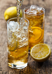 Image showing Pouring iced tea with lemon