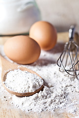 Image showing flour, eggs and kitchen utensil 