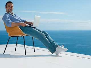 Image showing relaxed young man at home on balcony