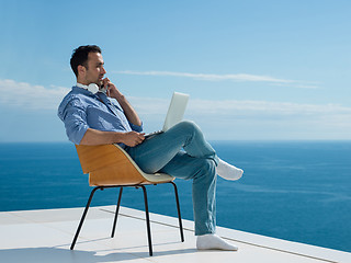 Image showing relaxed young man at home on balcony