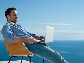 Image showing relaxed young man at home on balcony