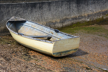 Image showing Weather-beaten dinghy on a concrete slipway