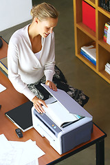 Image showing a businesswoman using copier machine