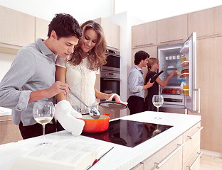 Image showing young friends preparing pasta