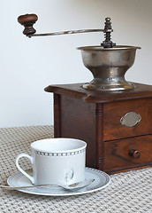 Image showing Coffee grinder and cup of coffee