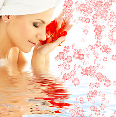 Image showing lady with red petals and flowers in water