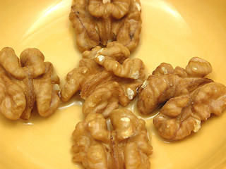 Image showing Walnut oil with walnuts in a bowl of ceramic in a close-up view