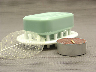 Image showing Green soap with decoration articles on a  gray background