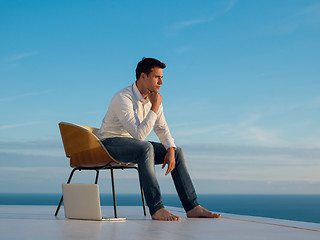 Image showing relaxed young man at home on balcony