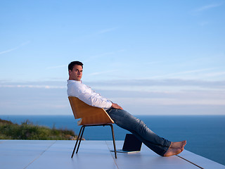 Image showing relaxed young man at home on balcony