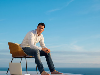 Image showing relaxed young man at home on balcony