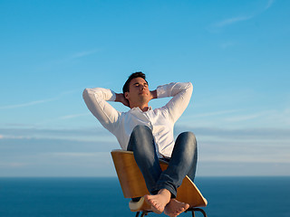 Image showing relaxed young man at home on balcony