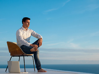 Image showing relaxed young man at home on balcony