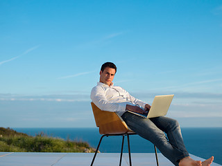 Image showing relaxed young man at home on balcony