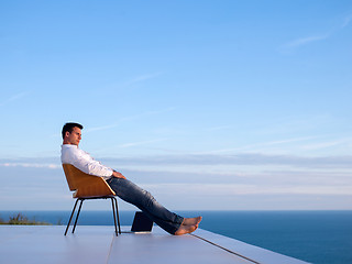 Image showing relaxed young man at home on balcony