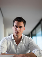 Image showing business man working on laptop computer at home