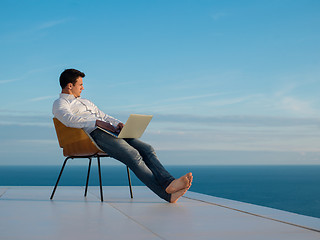 Image showing relaxed young man at home on balcony