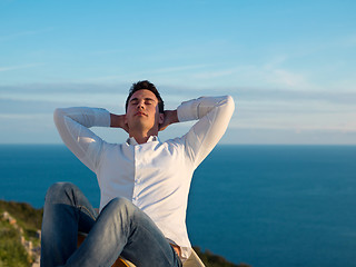 Image showing relaxed young man at home on balcony