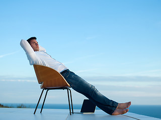 Image showing relaxed young man at home on balcony