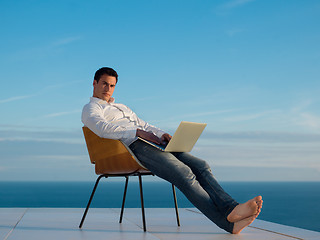 Image showing relaxed young man at home on balcony