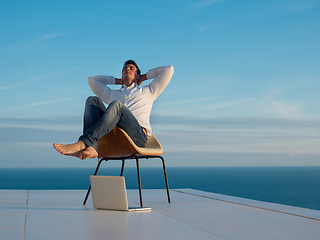 Image showing relaxed young man at home on balcony