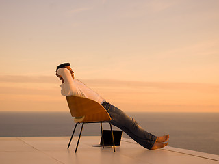 Image showing relaxed young man at home on balcony