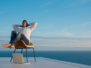 Image showing relaxed young man at home on balcony