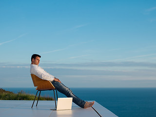 Image showing relaxed young man at home on balcony