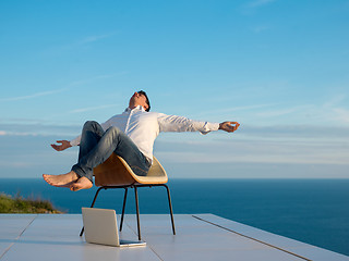 Image showing relaxed young man at home on balcony