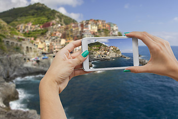 Image showing Manorola photographing with mobile phone