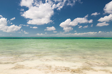 Image showing blue sea or ocean, white sand and sky with clouds