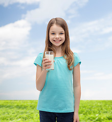 Image showing smiling little girl with glass of milk