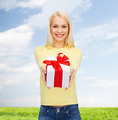 Image showing smiling girl with gift box